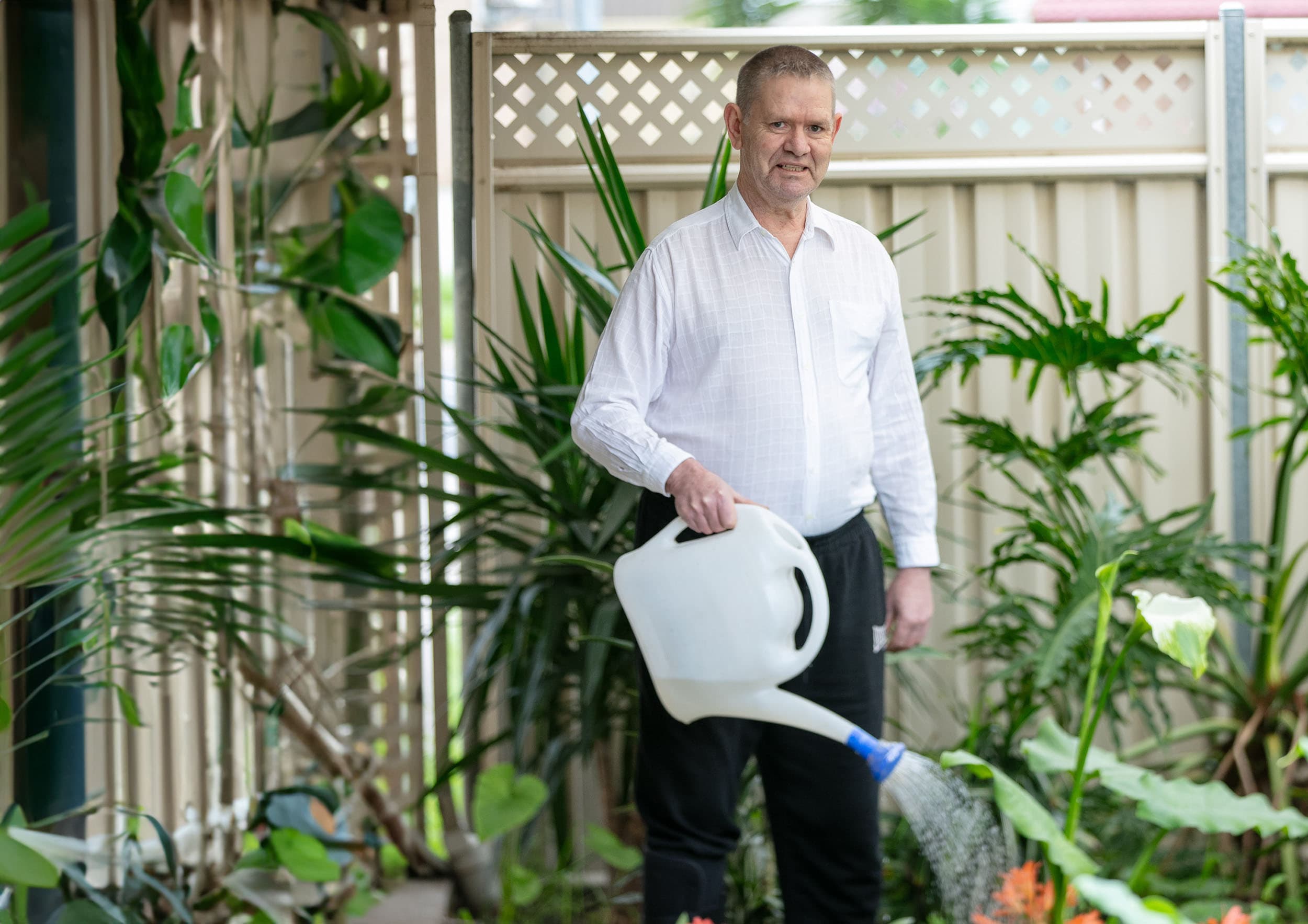 Man watering his garden.